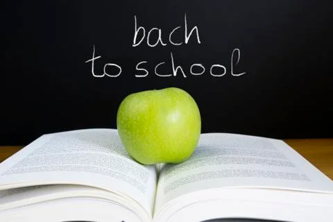 Back to school concept blackboard open books and apple. Stock Photos