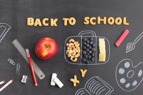 Back to school concept chalk board with accessories and lunch box note from Stock Photos