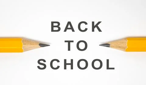 Back to school concept. Close-up two yellow pencils on white background with cop Stock Photos