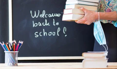 Back to school concept during covid - pile of books and medical mask Stock Photos