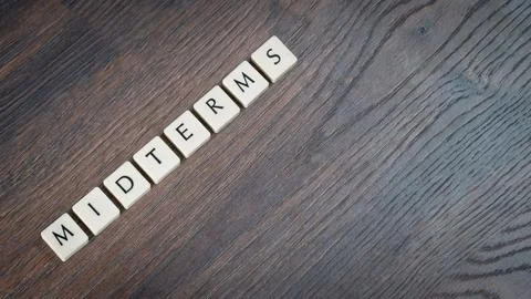 Back to school concept. Finals week word on wooden desk. Stock Photos