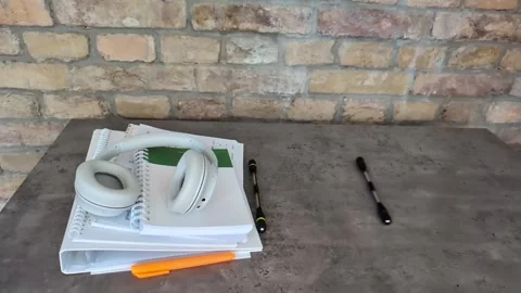 Back to school concept with  headphones,  notebooks and spinner pens rolling Stock Footage 338225507