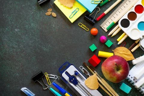 Back to school concept. Items for the school on blackboard dark table. Top vi Stock Photos