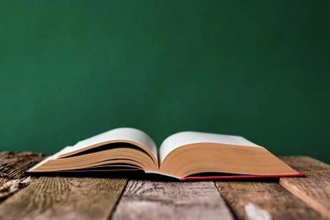 Back to school concept, open book on old wooden surface against a backdrop of Stock Photos