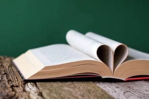 Back to school concept, open book and pages folded in the shape of a heart on 写真素材