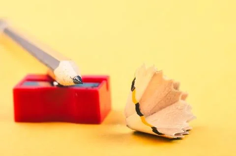 Back To school Concept, pencil with it shavings and sharpener over yellow bac Foto stock