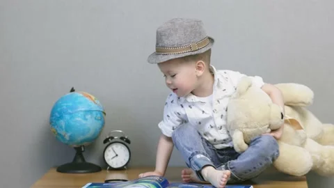 Back to school concept preschooler boy child sitting holding teddy bear in hands Stock-Footage 207563986