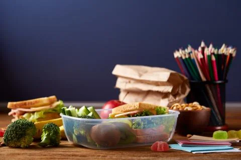 Back to School concept, school supplies, biscuits, packed lunch and lunchbox on Stock Photos