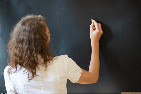 Back to school concept teacher in front of chalkboard Stock Photos