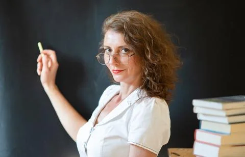 Back to school concept teacher in front of chalkboard Stock Photos