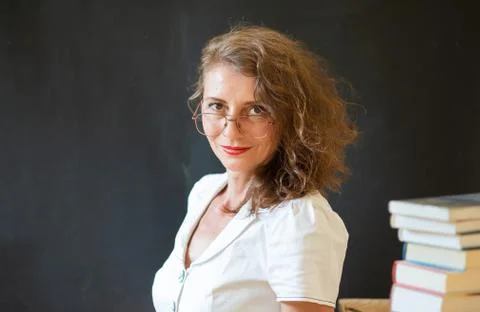 Back to school concept teacher in front of chalkboard Stock Photos
