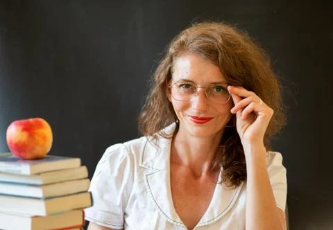 Back to school concept teacher in front of chalkboard Stock Photos