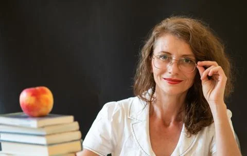 Back to school concept teacher in front of chalkboard Stock Photos