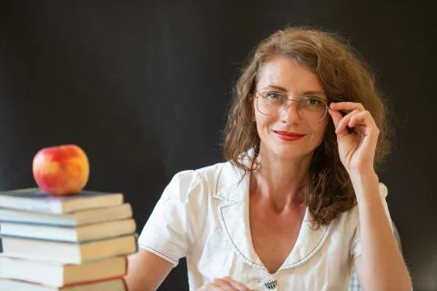 Back to school concept teacher in front of chalkboard Stock Photos