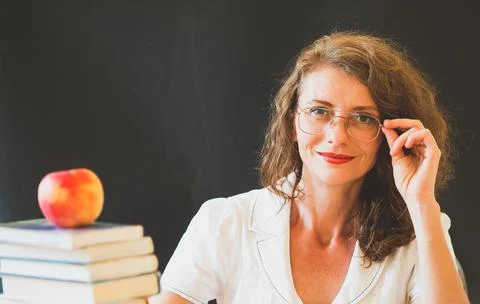 Back to school concept teacher in front of chalkboard Stock Photos