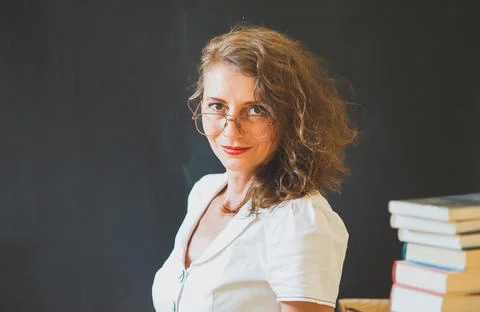 Back to school concept teacher in front of chalkboard Stock Photos