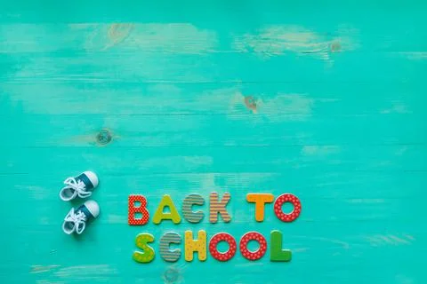 Back to school concept. Top view of colorful text and small shoes banner over Stock Photos