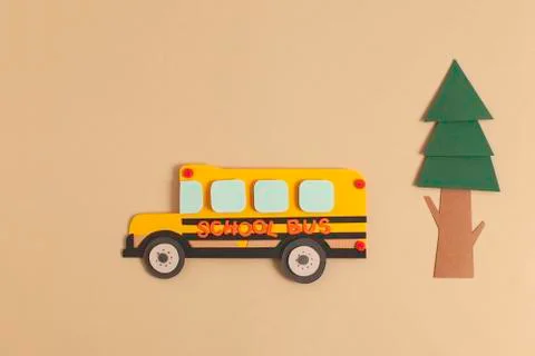 Back to school concept. Yellow bus with tree. Paper cutout artwork. Stock Photos