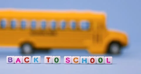 Back to school conceptual arrangement made with school bus toy on blue back.. 스톡 동영상 316920156
