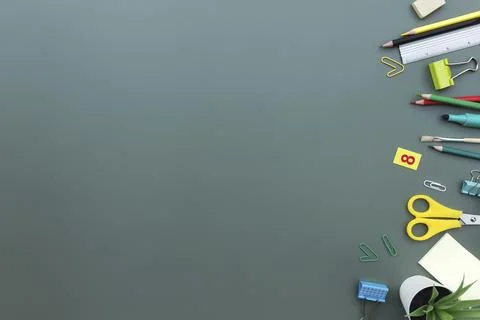 Back to school conceptual flat lay with different office supply objects on green Stock Photos