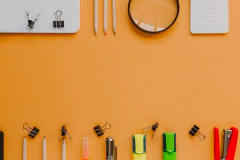 Back to school with copyspace concept, in orange color background. Stock Photos