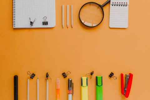 Back to school with copyspace concept, in orange color background. Stock Photos