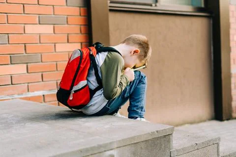 Back to school. Cute child with backpack, holding notepad and training books Stock Photos