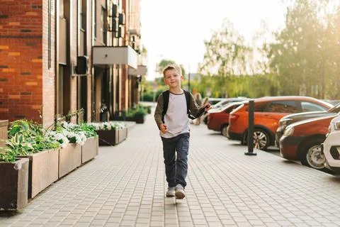 Back to school. Cute child with backpack running and going study to school. Boy Stock Photos