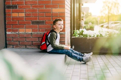 Back to school. Cute child with backpack, holding notepad and training books Stock Photos