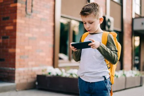 Back to school. Cute child with backpack running and going study to school. Boy Stock Photos