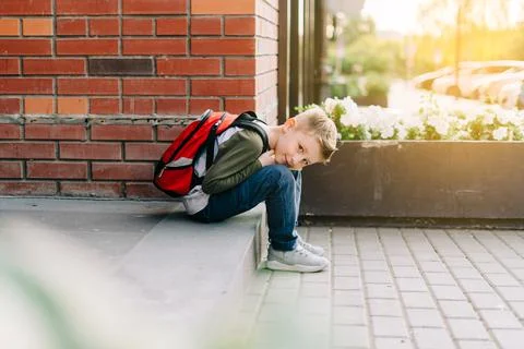 Back to school. Cute child with backpack, holding notepad and training books Stock Photos