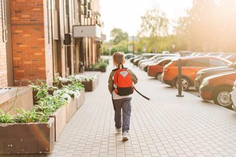 Back to school. Cute child with backpack going to school. Boy pupil with bag Stock Photos