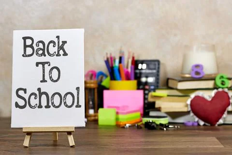 Back to School displayed on a mini easel Accompanied by Colorful Supplies and Bo Stock Photos