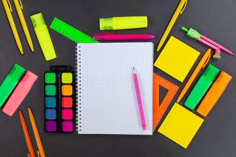 Back to school. Drawing. On black table lies notebook checkered with pencil Stock Photos