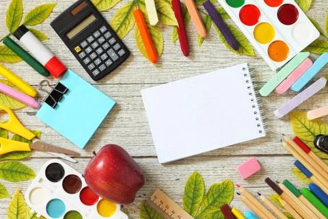 Back to school. Flatlay background. Table with autumn leaves, note pad, apple. Foto stock