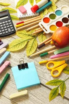 Back to school. Flatlay background. Table with autumn leaves, note pad, apple. Stock Photos