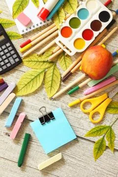 Back to school. Flatlay background. Table with autumn leaves, apple. Stock Photos