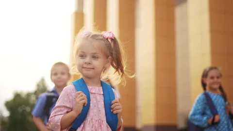 Back to school. a group of children with backpacks goes to school. school Stock Footage 252699257