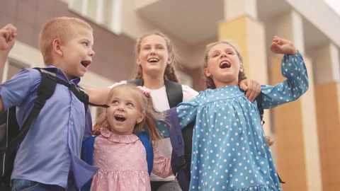 Back to school. a group of children with backpacks jumping to school. school Stock Footage 252699539