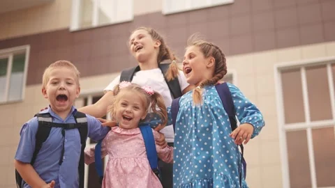 Back to school. a group of children with backpacks jumping to school. school Stock Footage 257439083