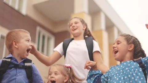 Back to school. a group of children with backpacks jumping to school. school Stock Footage 262451073