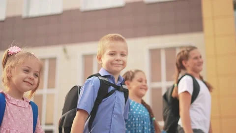 Back to school. a group of schoolchildren with backpacks walk next lifestyle to Stock Footage 170996064
