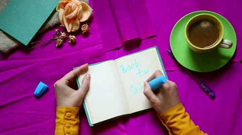 Back to school. Hands writing. Top view. Purple vintage background from above Stock Footage 57745942