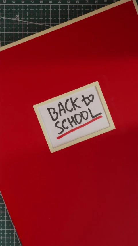 Back to School handwritten label on red notebook cover Stock Footage 341245985