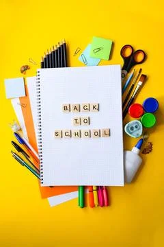 Back to School Handwritten Text on Grid Notebook Surrounded by Colorful School Stock Photos