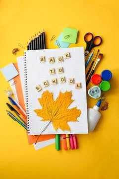 Back to School Handwritten Text on Grid Notebook Surrounded Stock Photos