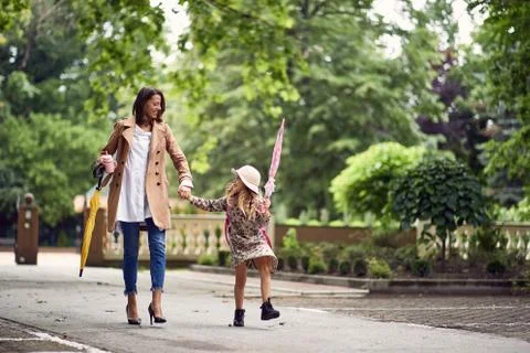 Back to school. Happy mother and daugther go to elementary school. Parent tak Stock Photos