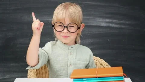Back to school. Happy pupil has idea in the classroom with blackboard background Stock Footage 201372435