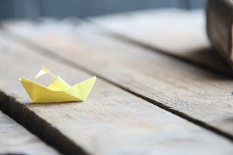 Back to school idea. Paper ship and book Stock Photos