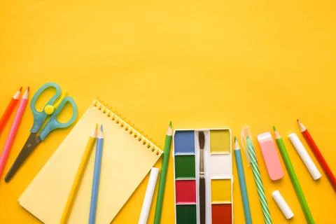 Back to school. Items for the school against yellow background. Stock Photos